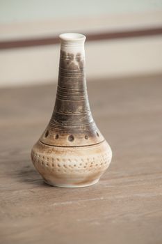 Traditional handcrafted vase of brown color on the table