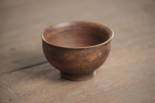 Traditional handcrafted dish of brown color on the table