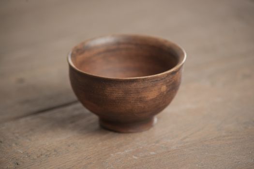 Traditional handcrafted dish of brown color on the table