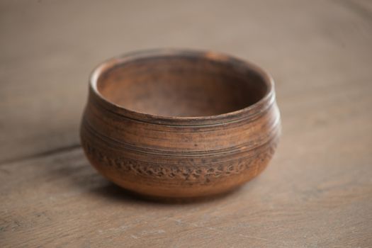 Traditional handcrafted dish of brown color on the table