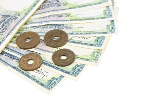 Pile of old ancient bill and coins of Thailand on white background.