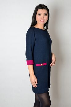 Asian woman wearing casual clothes, navy blue dress. Chinese female model, friendly face expression.