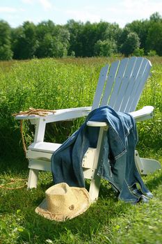 Jeans laying on chair in field