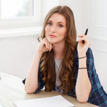 Student, office. Cute, beautiful woman by the table