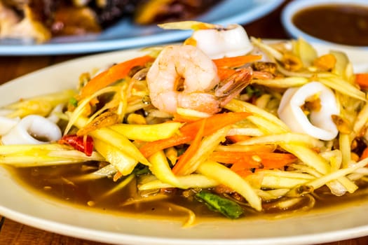 som tam,one of favorite thai menu that made from sliced papaya mixed with seafood