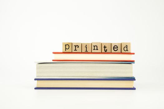 printed word on wood stamps stack on books, knowledge and academic concept