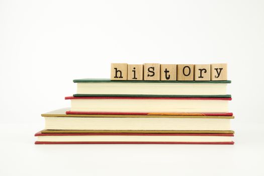 history word on wood stamps stack on books, knowledge and academic concept