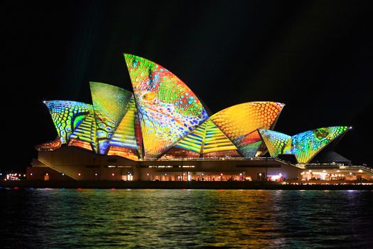 SYDNEY, AUSTRALIA - JUNE 2, 2014;  Vivid Sydney Festival, the Sydney Opera House in summery colours of lime, aqua, yellow and orange intricate patterns for Vivid  annual festival of light, music and ideas