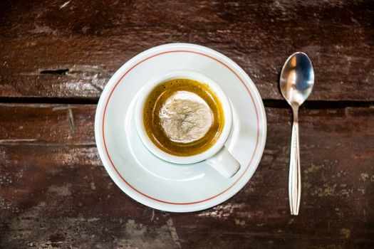 one cup of hot espresso on wood table,shalloe focus