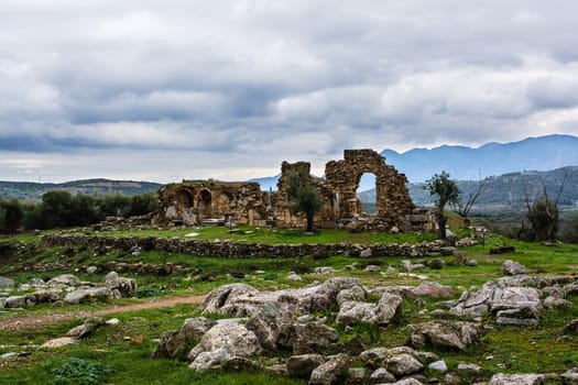 Pillar ruins at Ancient Troizina at dramatic sky, Peloponnese, Greece