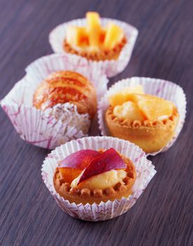 Different pastries over a dark wooden table