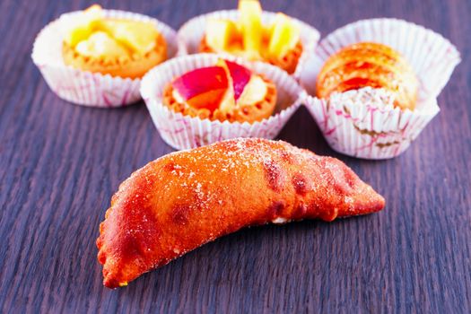 Some pastries over a dark wooden table