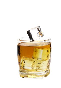 An ice cube about to fall into a glass of whiskey on the rocks.  Shot on white background.