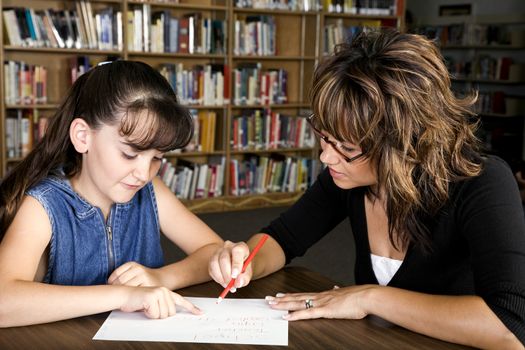 A little girl learning from her teacher.