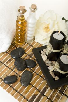 Spa products with massage stones, & aromatic candles.