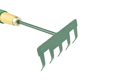 Green harrow placed upset with wooden handle on top left isolated with white background.