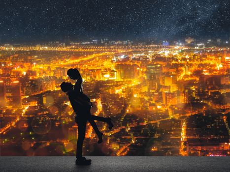 Silhouette of Asian couple, man hold his girlfriend up above the city in night under stars.