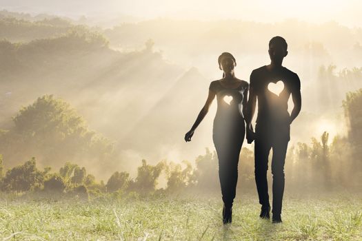 Lighting love, Silhouette of Asian couple hold hands walking on grassland.
