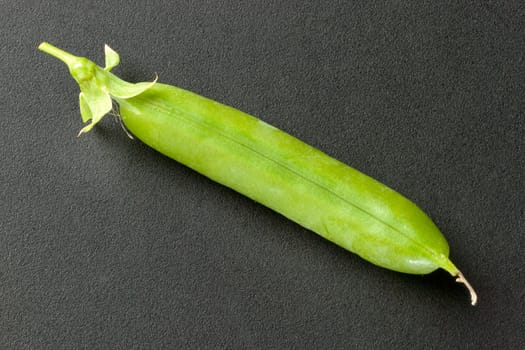 Close-up of a closed fresh pea pod.