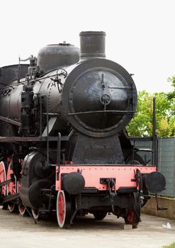 Old black and red locomotive, front view