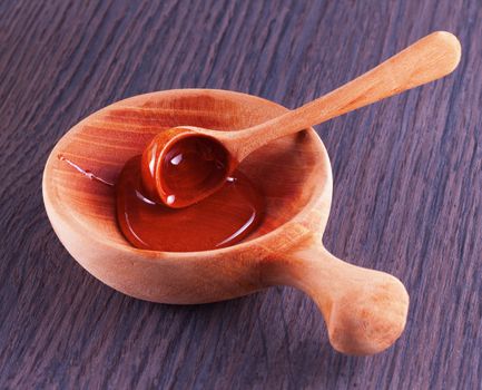 Honey in a wooden cup, with spoon