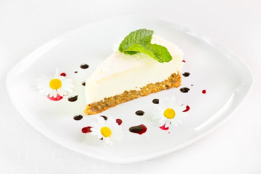 Dessert - Cheesecake with Green Mint decorated with dasiy flowers and decorated with fruit syrup drops.