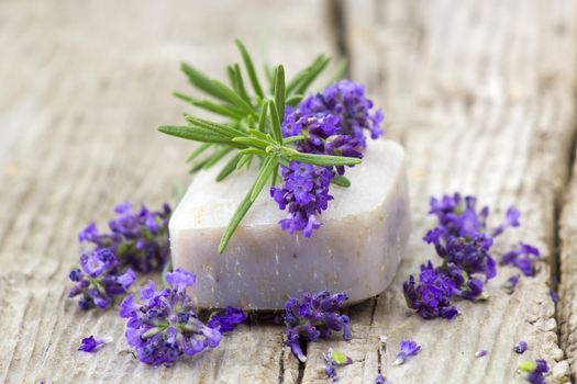 bar of natural soap and lavender flowers