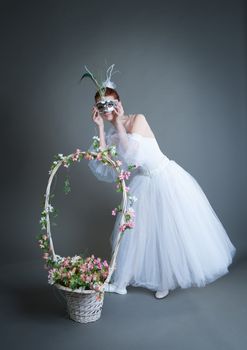 ballerina in the mask and with a basket of flowers