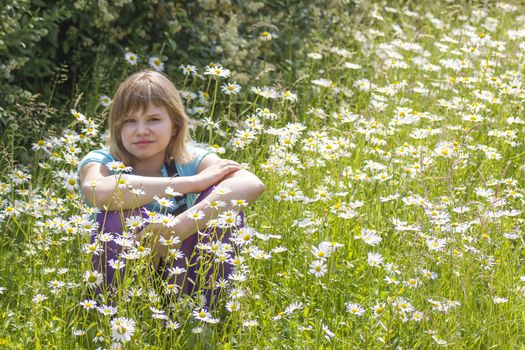 little girl on the meadow in summer day