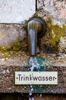 Old style faucet on the street in Austria
