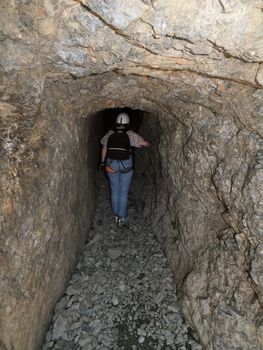 hiker in First world war tunnel in italian Alps