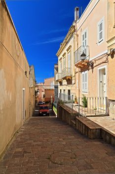 small street and the ancient walls in Carloforte, San Pietro Island, Sardinia, Italy