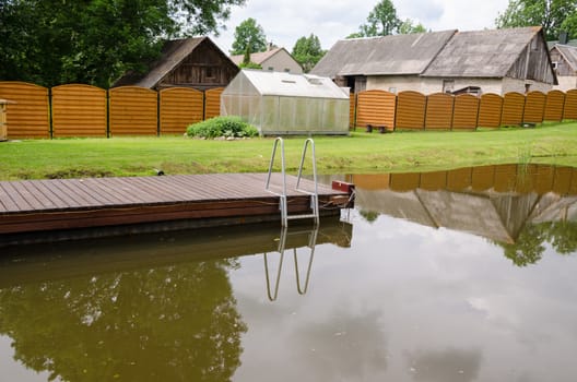 garden pond with long floating footbridge