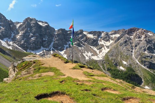 panoramic point with flags from San Nicolo' pass with Costabella ridge on background, Trentino, Italy