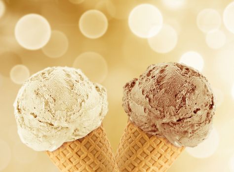 Vanilla and chocolate Ice cream in the cone with abstract light background.