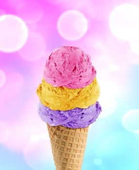 three Ice cream scoops in the cone with abstract light background.