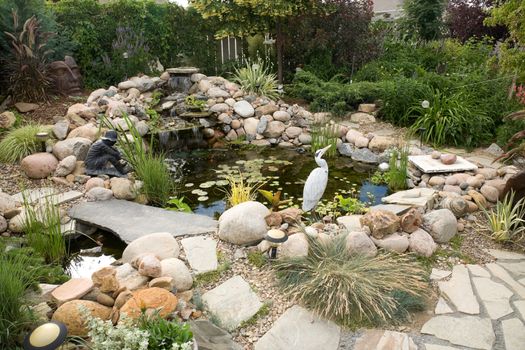 A large water feature turns a small backyard into a delightful summer retreat.