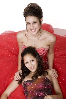 Two friends, who are often mistaken for sisters, in formal attire, ready for their prom.