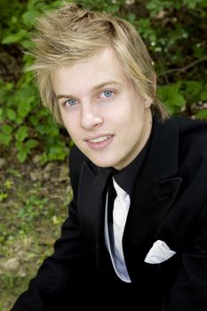 Young man with gorgeous blue eyes in formal suit.