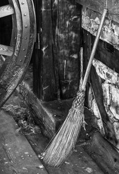 Old fashioned broom crafted with straw. Black and white for antique mood.