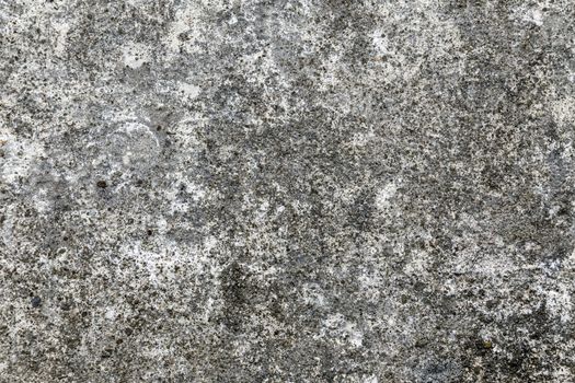 Close shot of the rough texture of gray concrete. Defects are seen. 