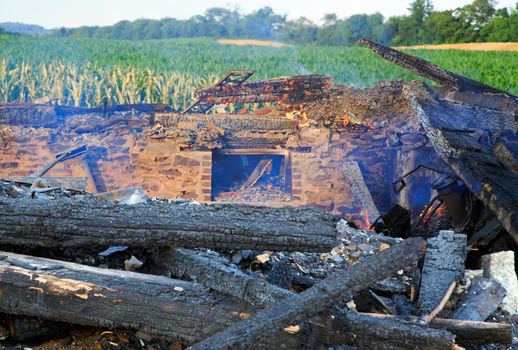 The smoldering remains of a rural home which was completely destroyed by fire.