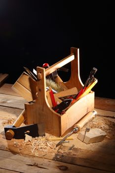 wooden tool box at work on a black background 