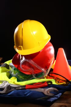 Stack of color helmets on black 