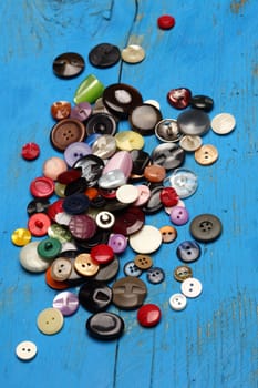 a pile of various colored buttons to sewing 