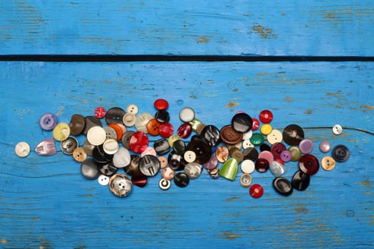 a pile of various colored buttons to sewing 