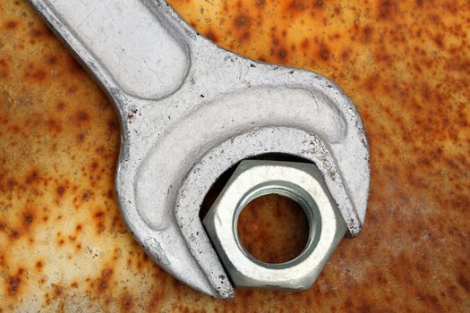 wrench and nut close up on rusty grunge 