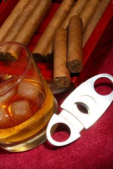 cigars in the box and glass with whisky, close up shallow dof 