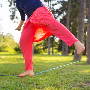 Slacklining is a practice in balance that typically uses nylon or polyester webbing tensioned between two anchor points.