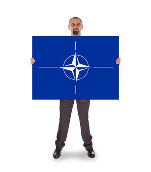 Businessman holding a big card, NATO symbol, isolated on white